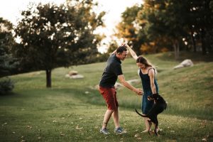 man, woman, dog in woods
